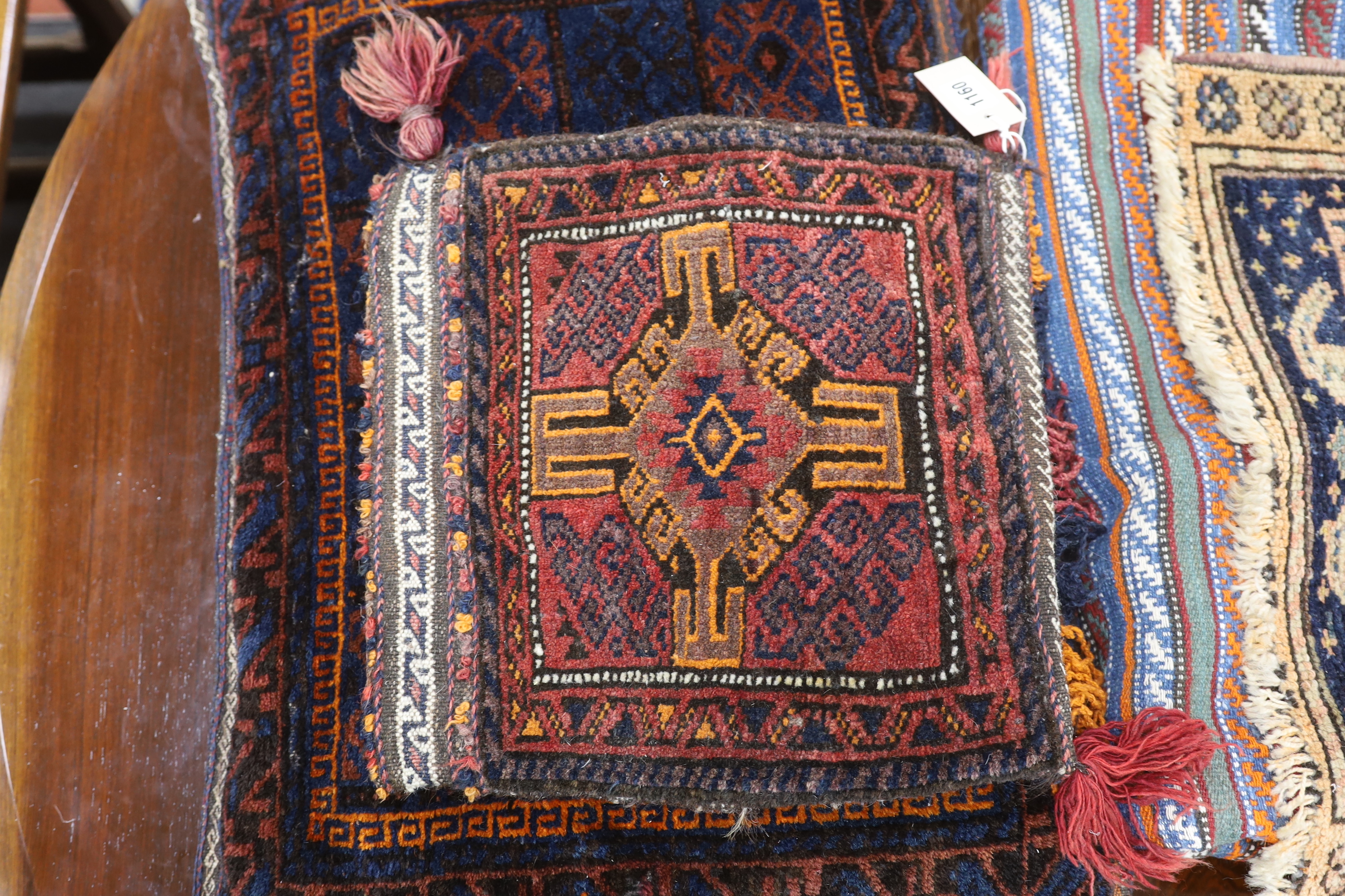 A Belouch cushion, two textile fragments, a Caucasian geometric salt bag, Caucasian mat and a flatweave rug, largest 220 x 205cm